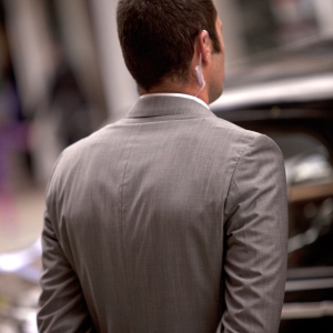 Close protection officer waiting for clients to emerge from a building