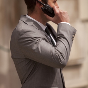 A close protection officer in radio contact with colleagues