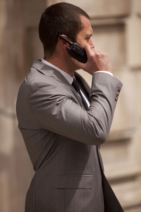 A close protection officer in radio contact with colleagues