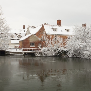 Snow covered Flatford Mill on the River Stour in suffolk