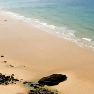 An aerial view of the wide sandy beach at Watergate Bay, Cornwall