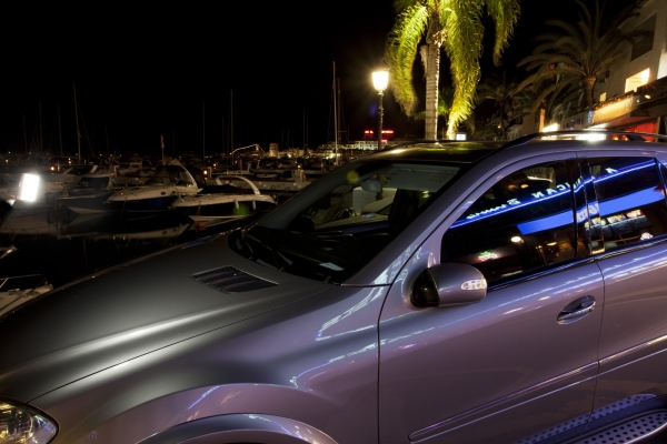 Luxury cars and yachts at the marina in Puerto Banuz, Southern Spain