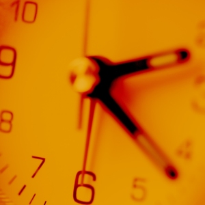 Close up view of orange tinted clock face