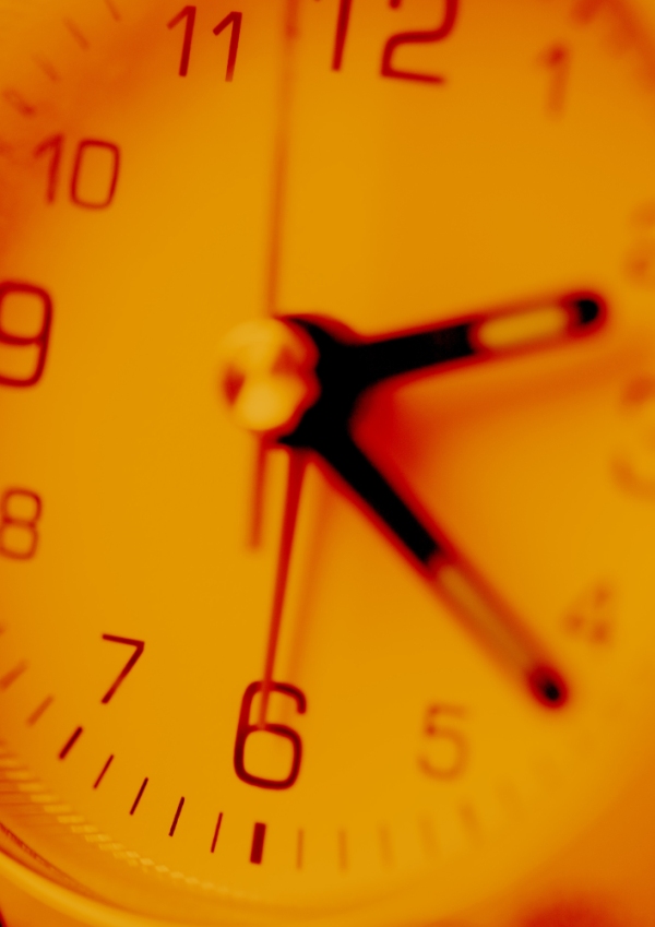 Close up view of orange tinted clock face