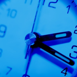 A close up view of a blue tinted clock face