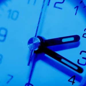 A close up view of a blue tinted clock face