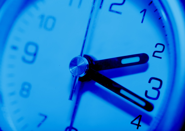 A close up view of a blue tinted clock face