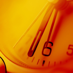 Close up view of an orange tinted clock face