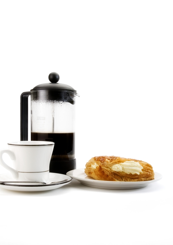 A cup of coffee with some arabica coffee beans, jam and doughnut