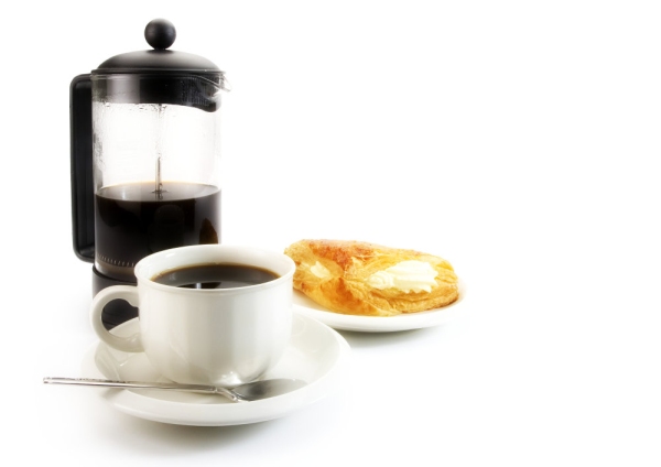 A cup of coffee with some arabica coffee beans, jam and doughnut