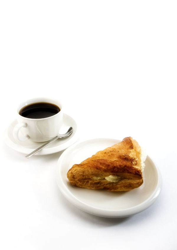 A cup of fresh coffee with a cream filled apple turnover