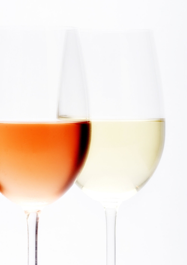 Two wine glasses, one rosé, one white