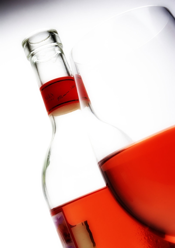 Rosé wine in a glass and bottle, close up view