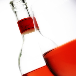 Rosé wine in a glass and bottle, close up view