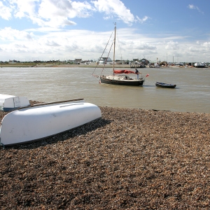 Upturned boats on the shingle beach at Bawdesey in Suffolk