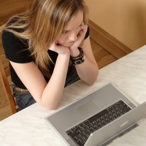 Young girl working on a laptop computer, seen from above