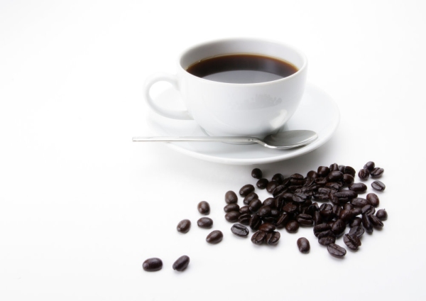 A cup of fresh coffee with some coffee beans