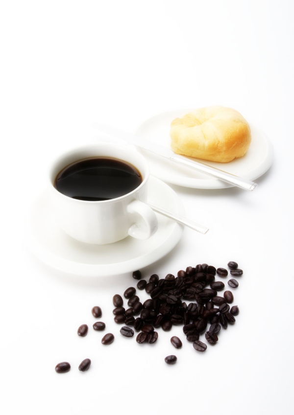 A cup of fresh coffee with doughnut and beansA cup of fresh coffee with doughnut and beans