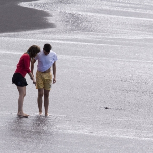 A couple enjoying the black beach in Tenerife