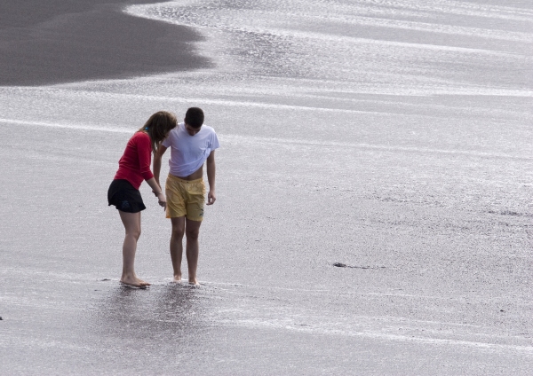 A couple enjoying the black beach in Tenerife