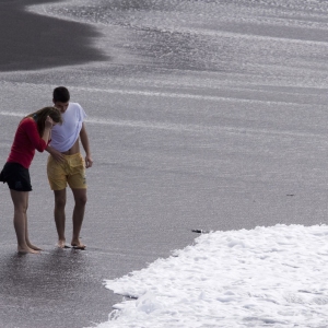 A holidaying couple enjoying an evening walk along the beach in Tenerife