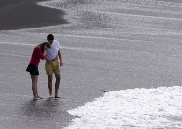 A holidaying couple enjoying an evening walk along the beach in Tenerife