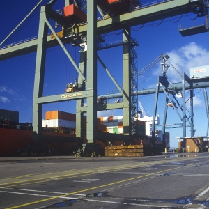 Large dockside cranes preparing to unload containers from a ship