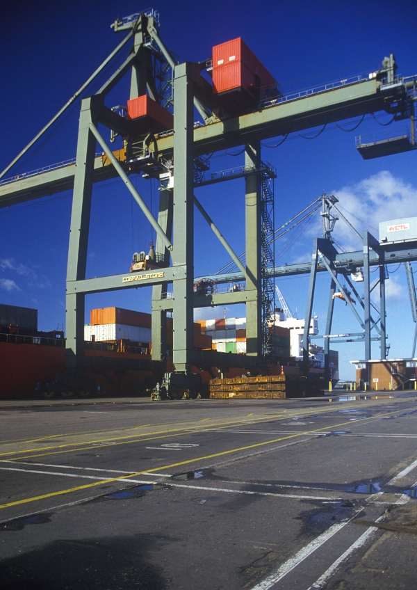 Large dockside cranes preparing to unload containers from a ship