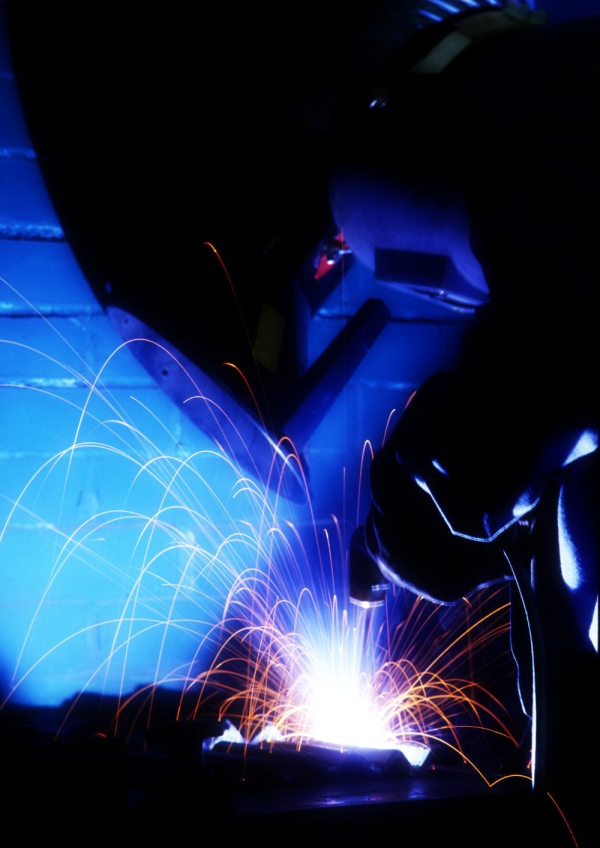 An electric grinder or spot welder working in a dark environment