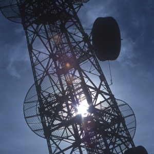 Backlit photo of a communications mast