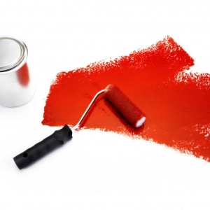 A paint roller with red paint