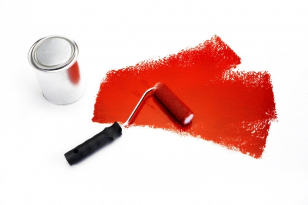 A paint roller with red paint