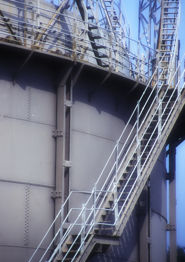 A close up of an oil or chemical storage tank in a tank farm at a container port