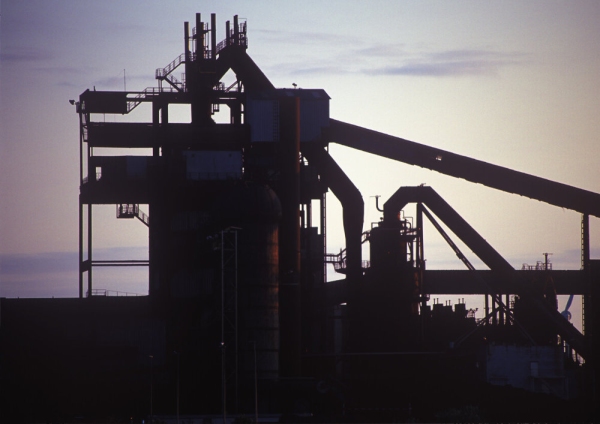 A silhouette of a large sand and gravel works