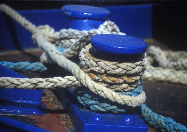 Capstans on the dockside with large mooring ropes attached