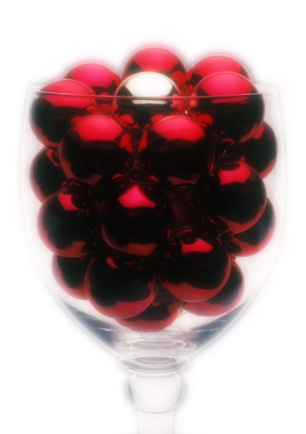 Red Christmas baubles in a large wine glass