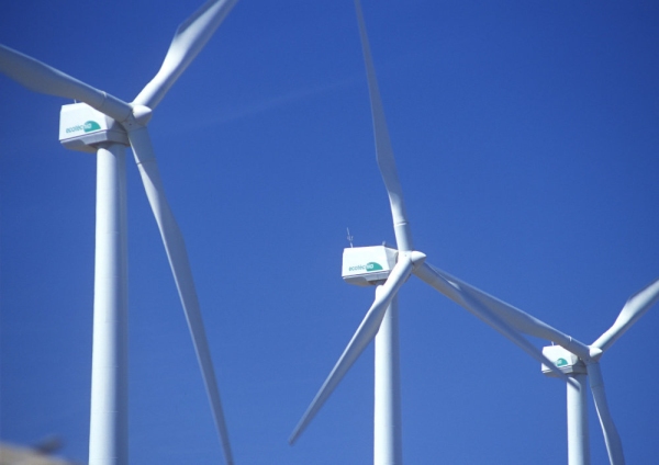 Wind turbines against a clear blue sky