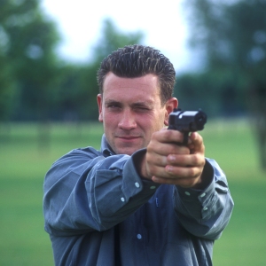 A man practising his firearm skills on the firing range.