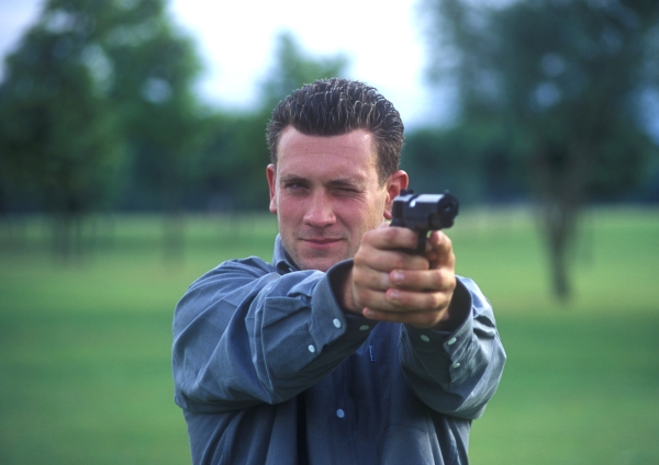 A man practising his firearm skills on the firing range.