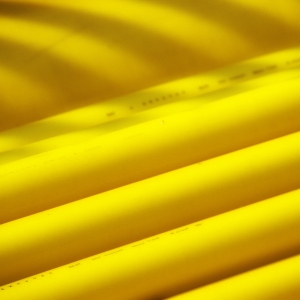 Yellow ducting and pipework on a construction site