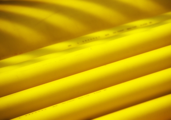 Yellow ducting and pipework on a construction site