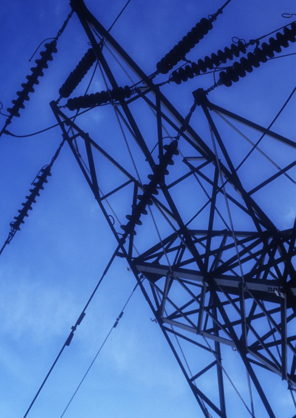 Electricity pylons against a clear blue sky