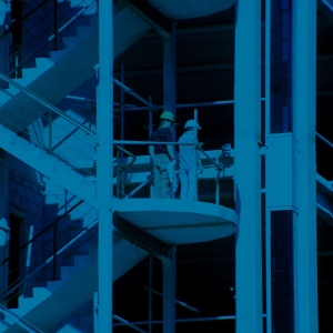 A blue tinted image of a multi storey building under construction