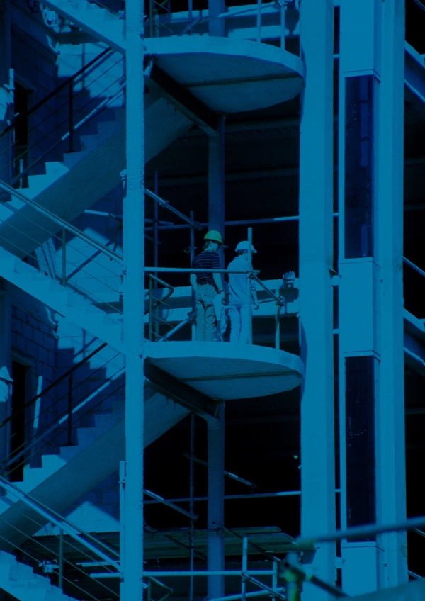 A blue tinted image of a multi storey building under construction