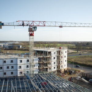 A large crane working on a commercial construction site