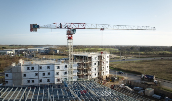 A large crane working on a commercial construction site