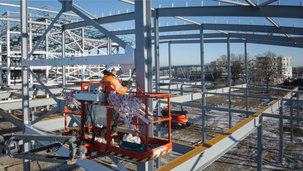 Workers on a large commercial construction site