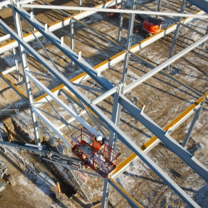 Workers on the steel frame of a large construction site