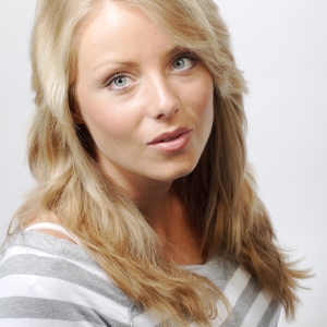 Pretty blonde girl in a striped top looking up at the camera