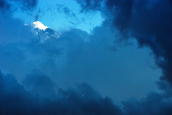 Blue and white cumulo nimbus storm clouds